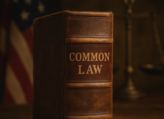 Brent Allan Winters Exposes the Legal Tyranny That Replaced America’s Biblical Common Law Antique leather-bound book titled Common Law on a wooden table, styled in 1776 patriotic American setting